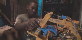 Cameroonian child build bulldozer from recycled materials