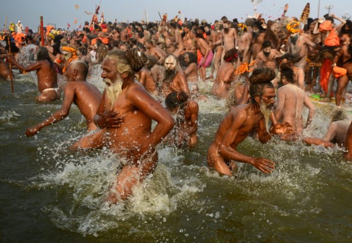Millions of Hindu pilgrims took the plunge into sacred rivers at the world's largest religious gathering Monday, led by ash-smeared holy men and accompanied by religious chanting. On the most auspicious day of the months-long Kumbh Mela festival, devotees rose at dawn in the northern city of Allahabad to immerse themselves at the confluence of three rivers -- the Ganges, the Yamuna, and the mythical Saraswati. Thousands of Naga Sadhus, a devout, fierce and famously nude sect of followers of the Hindu god Shiv, and other holy men clad in saffron robes, led the mass bathing in the chilly waters, some brandishing swords and tridents. Hindus believe that bathing in the sacred rivers cleanses them of sin and Monday's Mauni Amavasya Snan -- the 