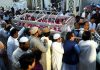 Burial services start as town grieves casualties of Pakistan train fire